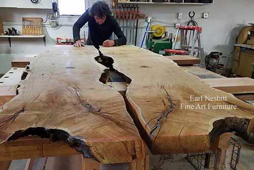 Earl designing notch for glass on mesquite slab for custom made live edge dining table